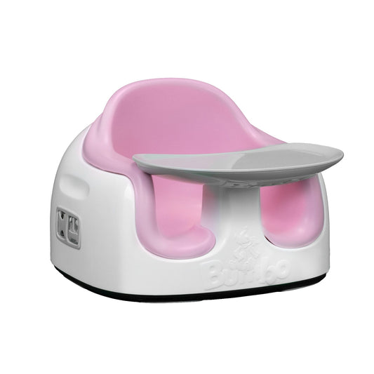 Pink and white baby seat with tray on a white background