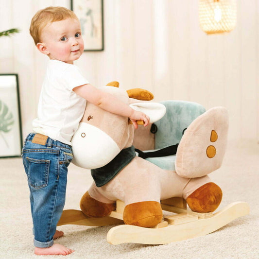 Child playing with a plush rocking horse toy indoors.