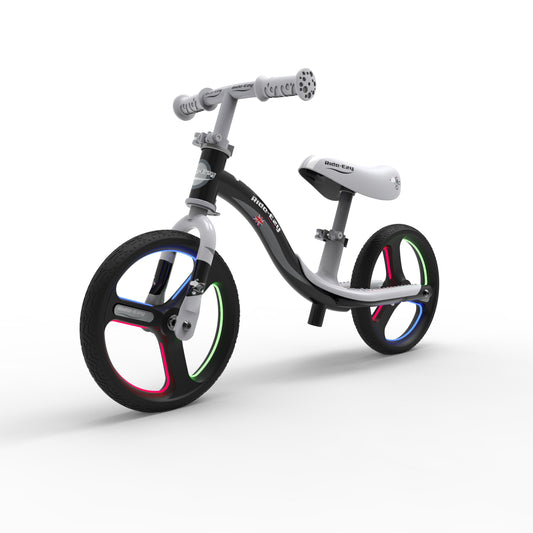 Children's balance bike with colorful wheels on a white background