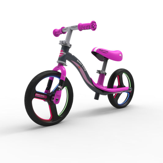 Children's balance bike with pink accents on a white background