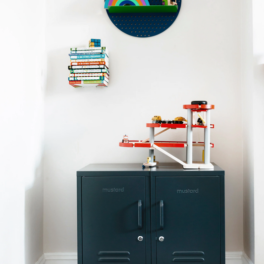 Children's room with a blue locker, colorful toys, and a rainbow decoration on the wall.
