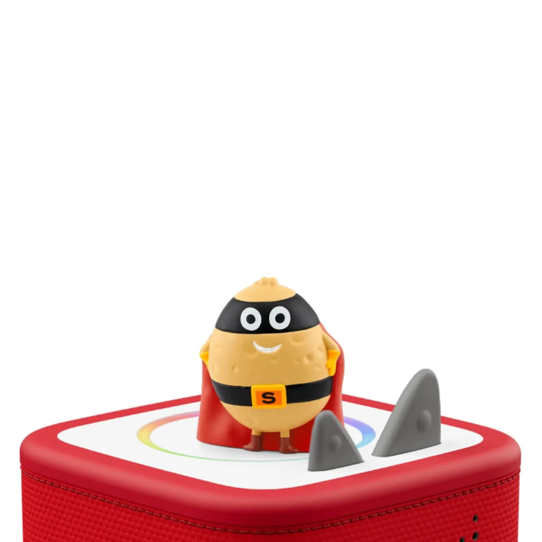 Toy figure of a character with a red cape and shark fin on a white background