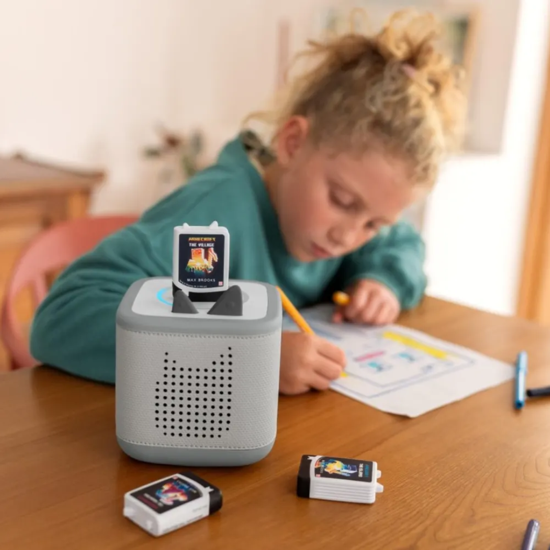 Child using a educational device on a table with colorful screens