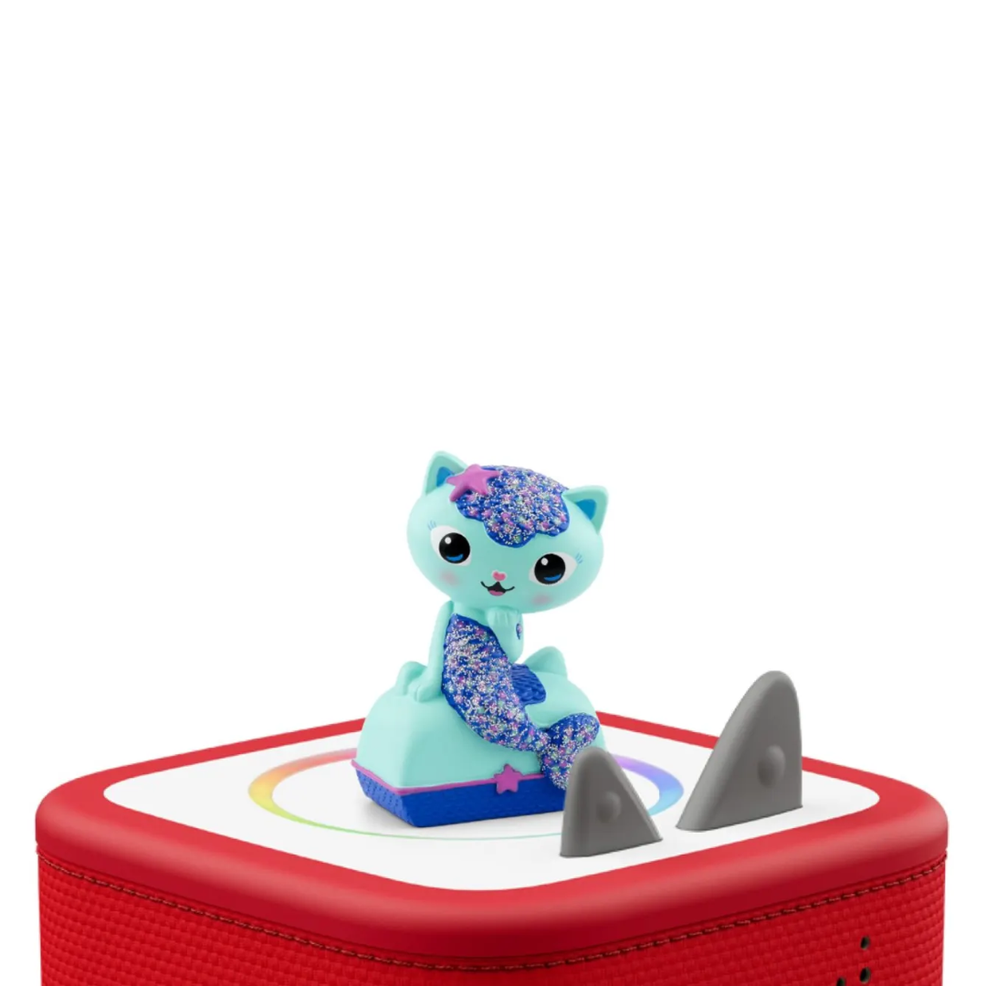 Toy figure of a cat-like character on a red and white platform with a shark fin.