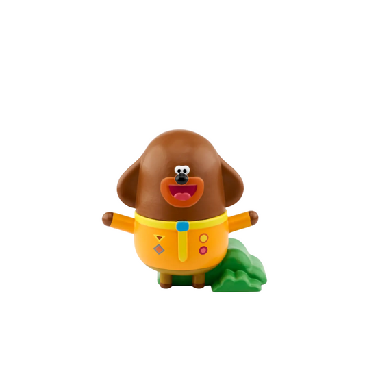 Toy figure of a cartoon dog with a colorful outfit on a white background