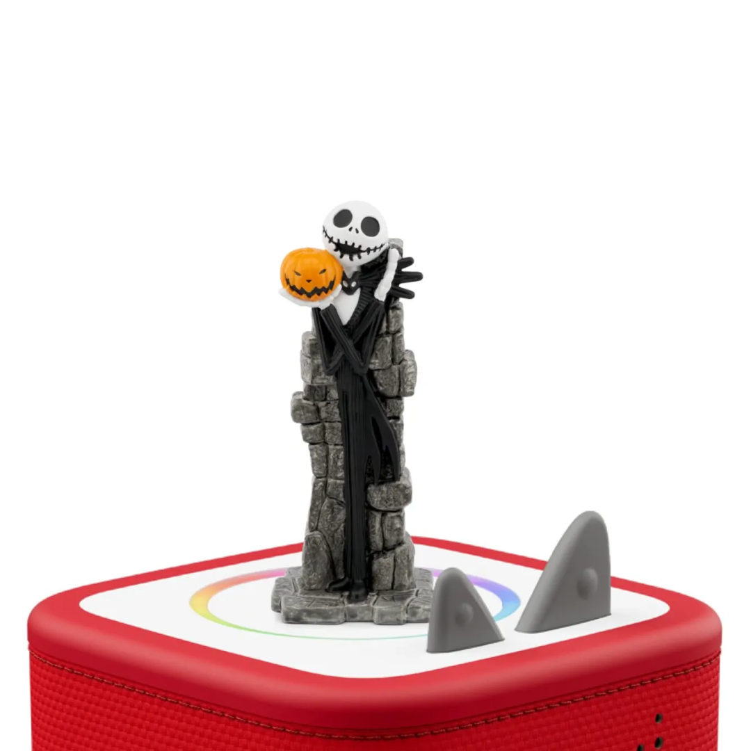 Skeleton figure with a pumpkin head on a red and white base