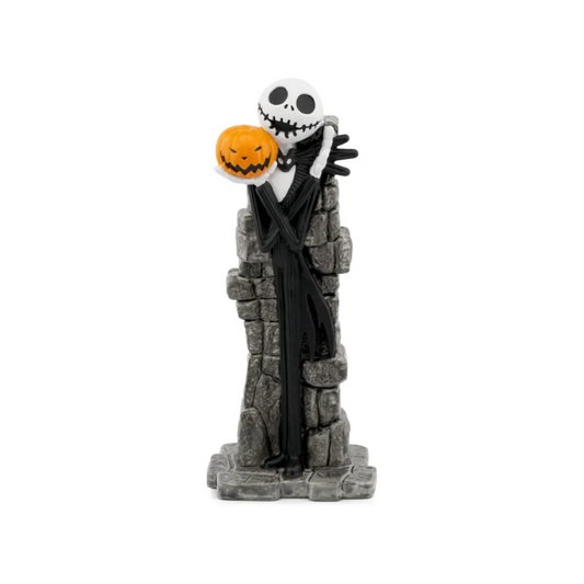 Skeleton figure with pumpkin head on a stone pedestal against a white background