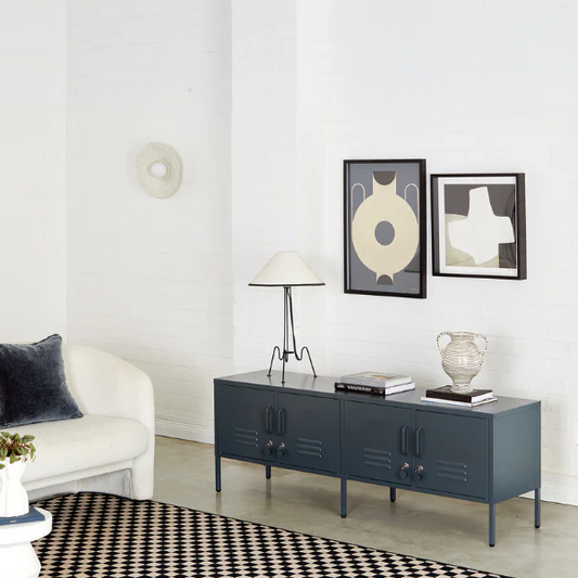 Modern living room with a blue cabinet, white sofa, and decorative items.