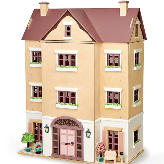 Toy dollhouse with a brown roof and beige walls on a white background