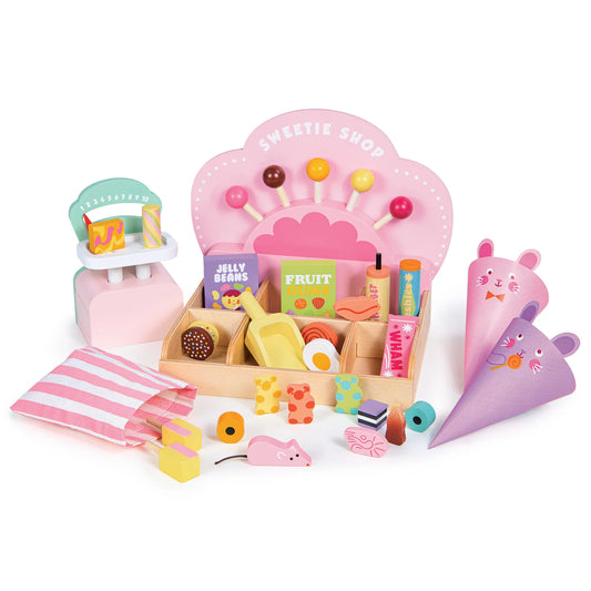Toy set with a candy shop display, fruit stand, and various toy items on a white background