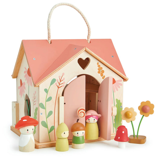 Wooden toy house with colorful doors and small figures on a white background