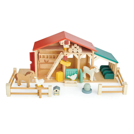 Toy farm set with barn, animals, and accessories on a white background