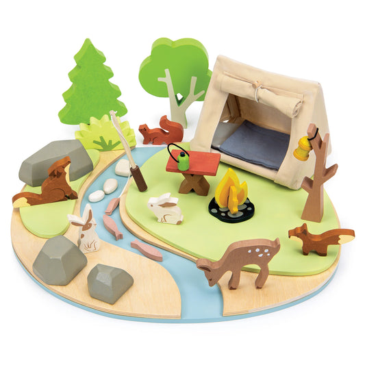 Wooden playset with a campsite, trees, animals, and a tent on a white background