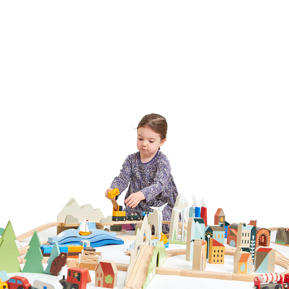Child playing with a wooden toy set on a white background