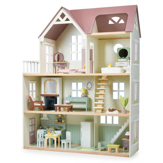 Wooden dollhouse with detailed interior furniture on a white background