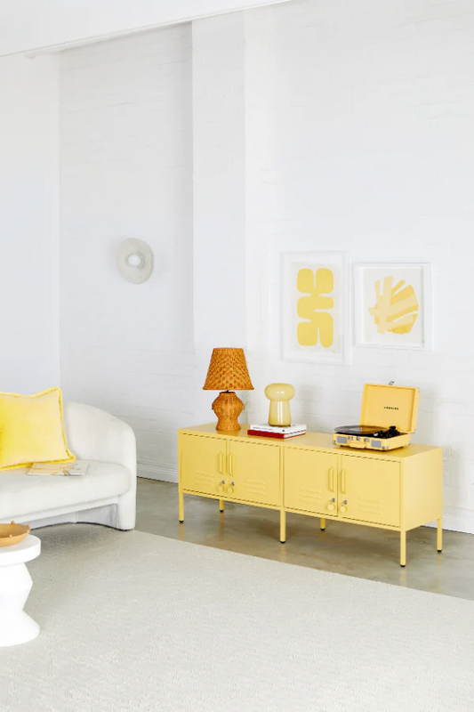 Yellow sideboard in a living room with decor items