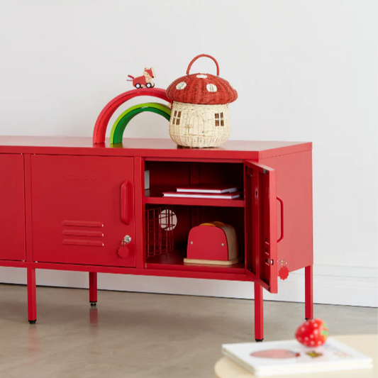 Red children's cabinet with open door, toys, and a colorful rainbow decoration in a room.