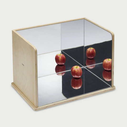 Wooden Exploratory mirror with an apple reflecting over the surfaces