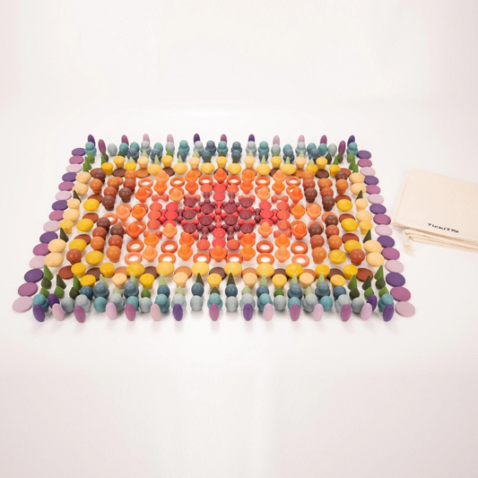 Colourful wooden loose parts lined in colour sets