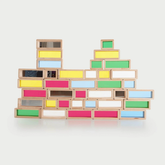 Colourful wooden blocks stacked against a white background
