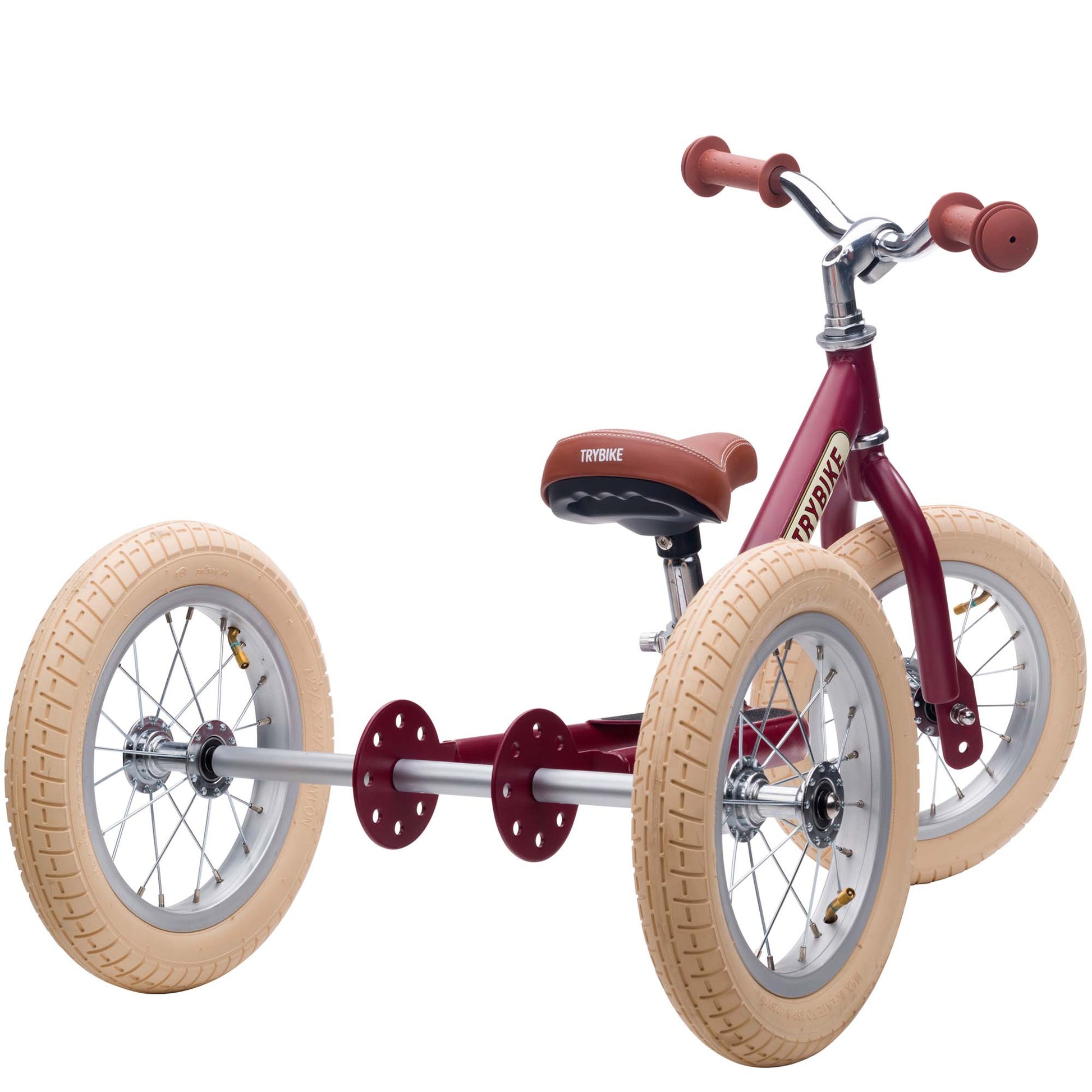 Red tricycle with tan tires on a white background