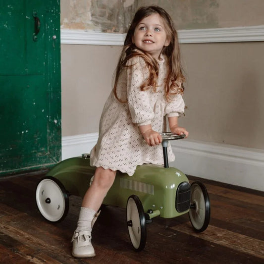 Khaki green ride on toy car with child riding it