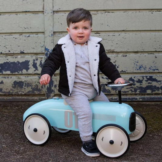 Children's toy car with number 01 with child riding on it