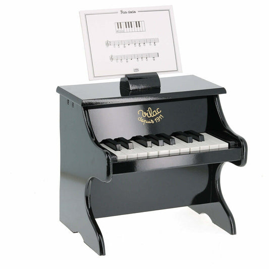 Toy piano with music stand on a white background