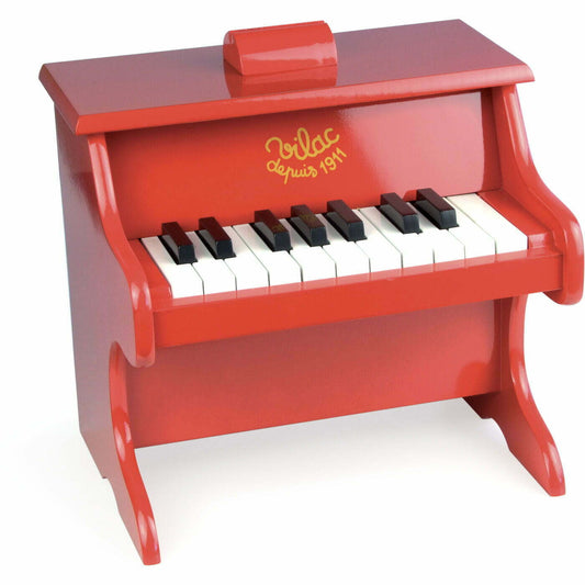 Red toy piano on white backbround