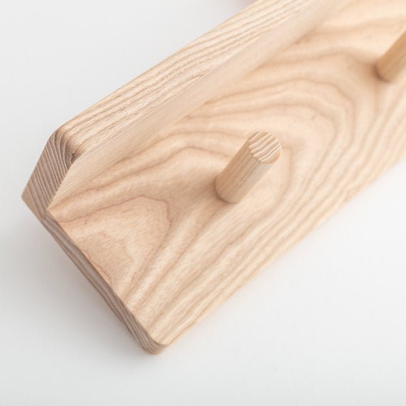 Wooden block with a small hole on a white background