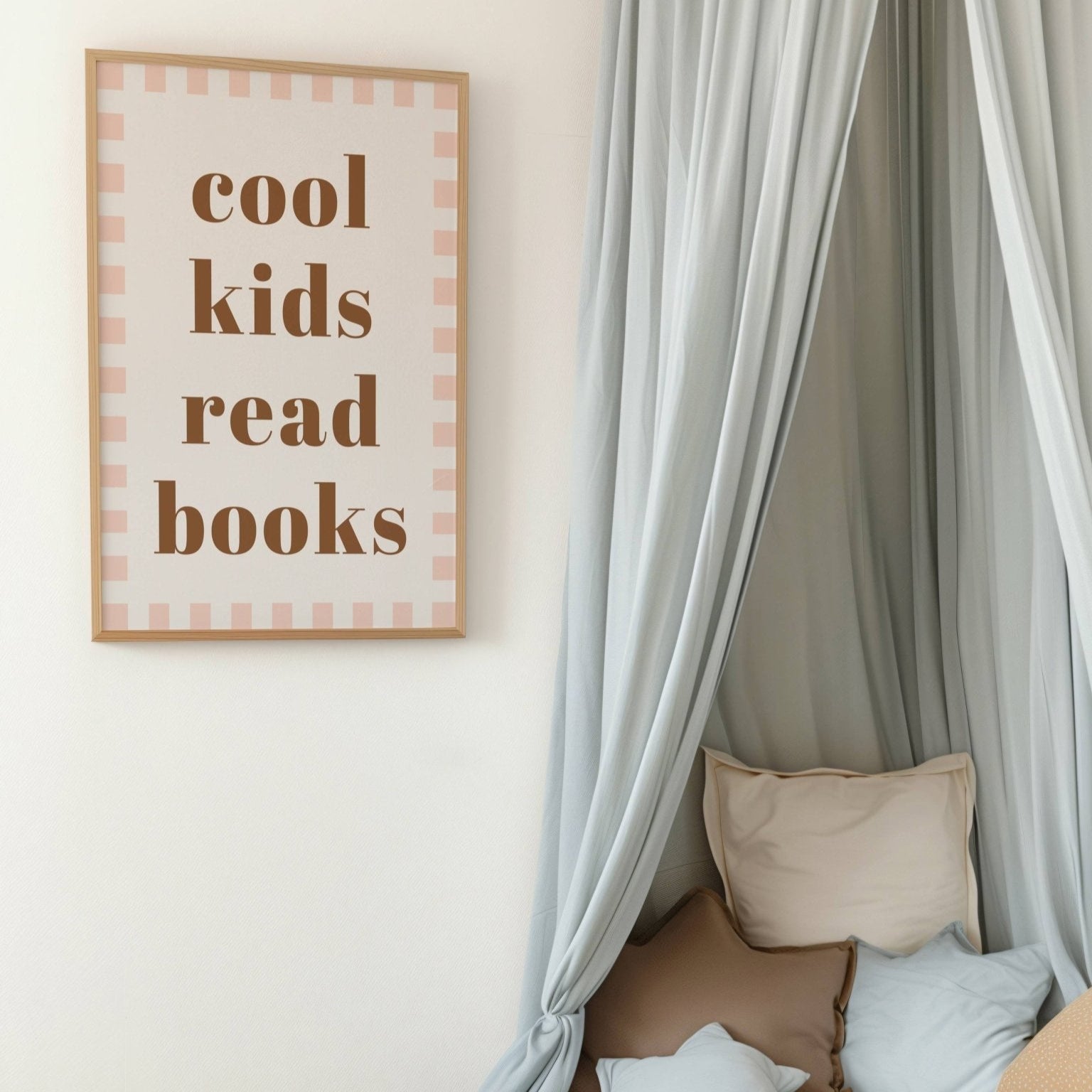 Children's reading nook with a framed sign, teddy bear, and cushions.