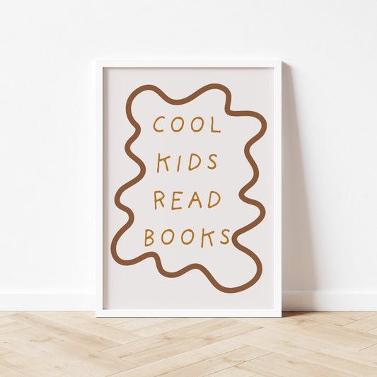 Framed poster with 'Cool kids read books' text on a white wall.