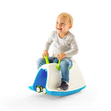 Child sitting on a blue and green toy horse with a white background