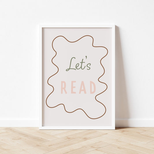 Framed poster with 'Let's Read' text on a white wall.