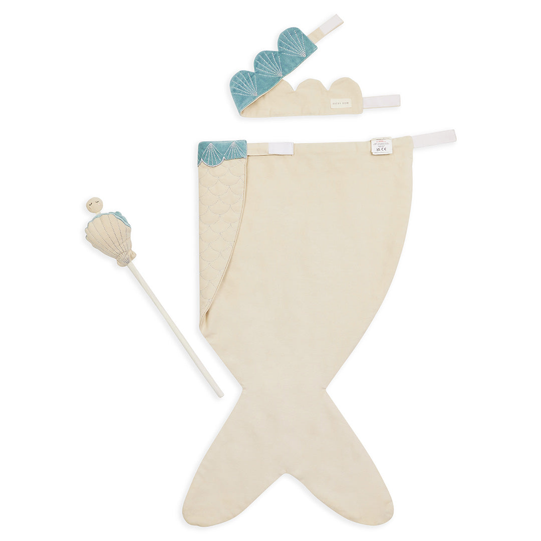 Beige mermaid tail with blue fins and a white wand on a white background