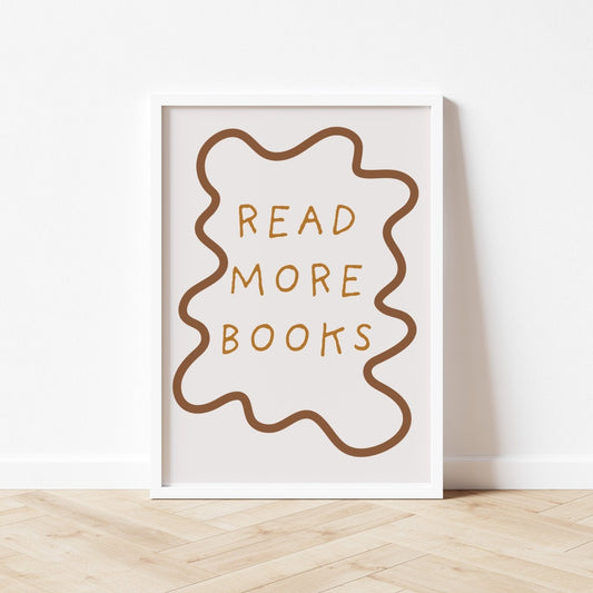 Framed poster with 'Read More Books' text on a white wall.
