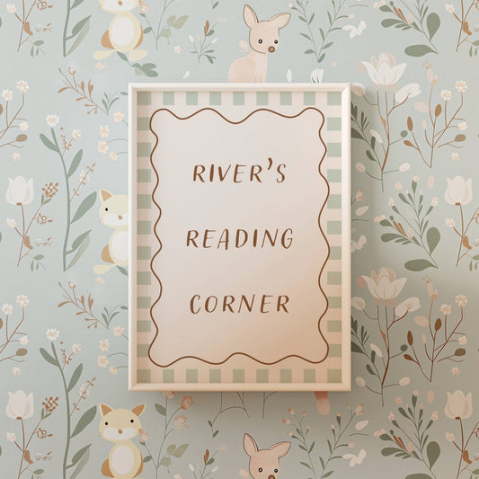 Framed sign with 'River's Reading Corner' on a floral and animal wallpaper background