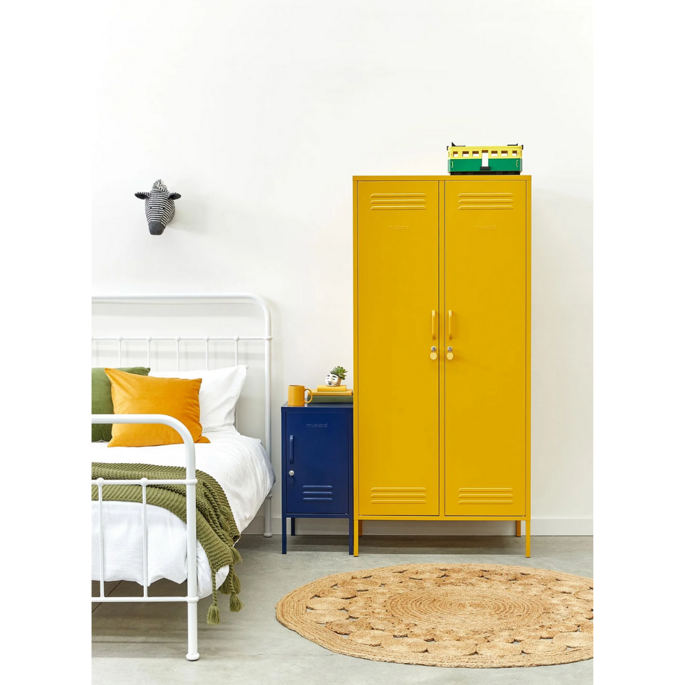 Yellow locker in a room with a bed and round rug