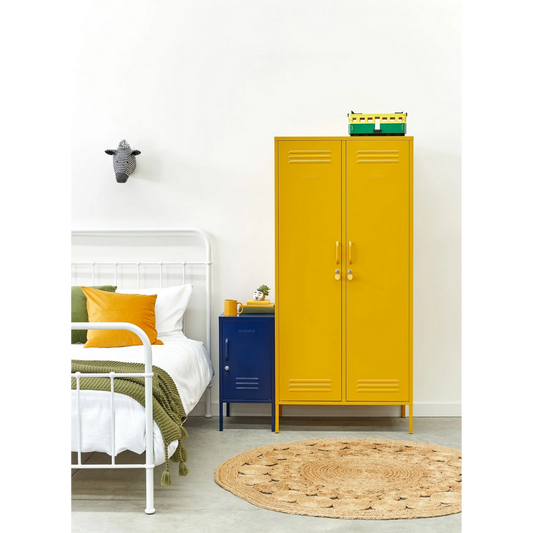 Yellow locker in a room with a bed and round rug