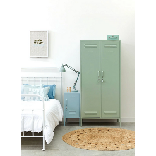 Modern bedroom with green locker, white bed, and blue nightstand.