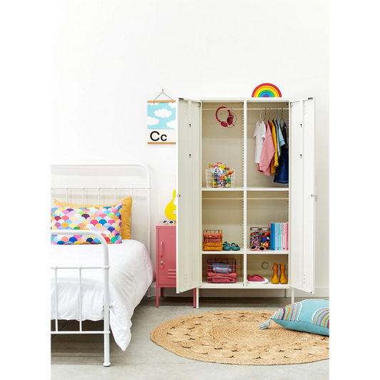 Children's room with a white wardrobe, bed, and colorful decor