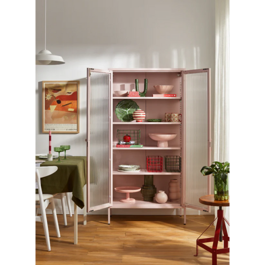 Pink cabinet with the door open in a dining room