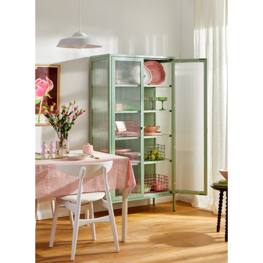 Sage green cabinet with glass door open in a dining room setting
