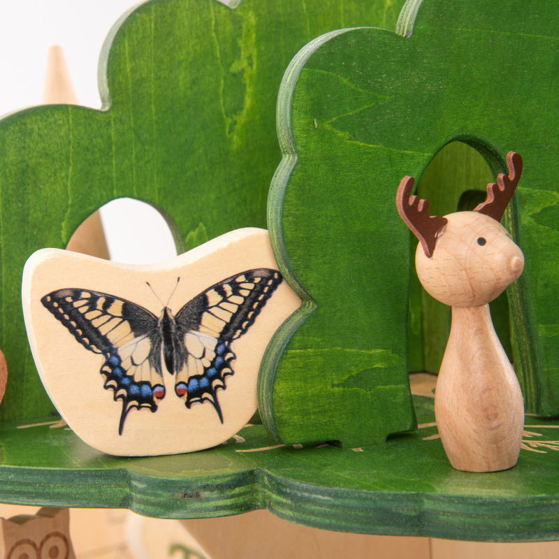 Wooden toy set with butterfly, deer, and tree .