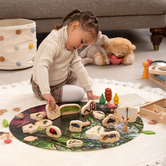 Child playing with wooden toys on a play scene
