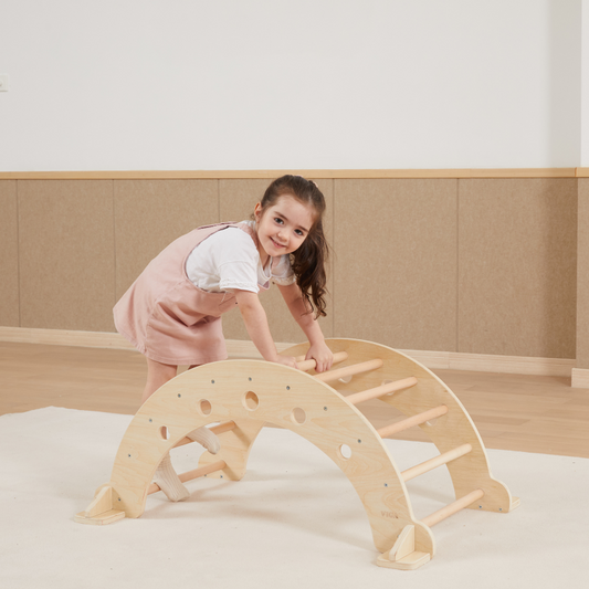Child playing with a wooden climbing arch