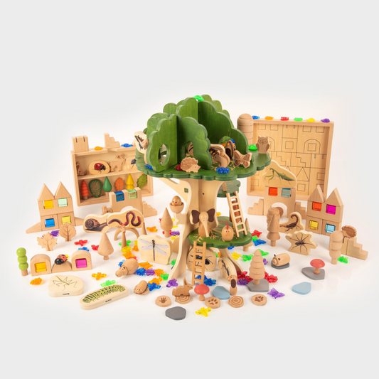 Toy treehouse set with various wooden pieces on a white background