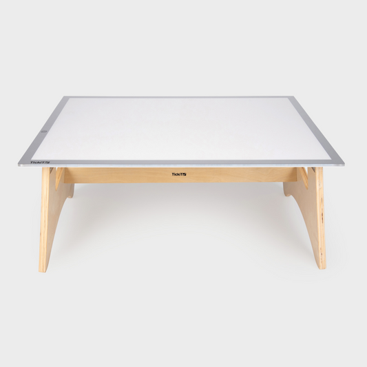 Rectangular table with a light panel on top and wooden legs on a white background