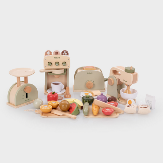Set of wooden toy kitchen appliances and food items on a white background