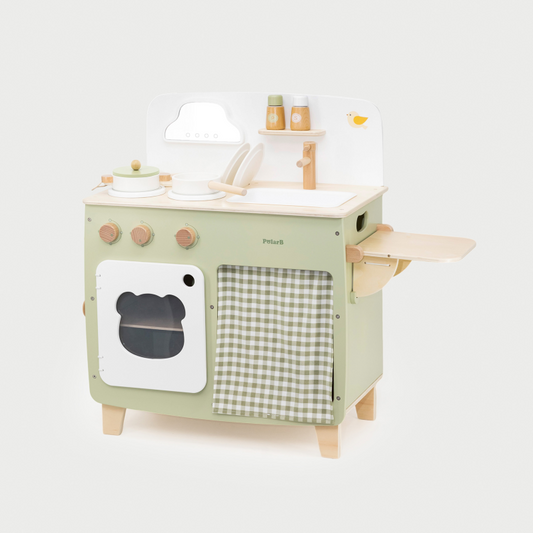 Children's play kitchen set with green oven and white countertop on a light gray background
